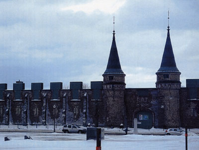 Central arched doorway flanked by towers.